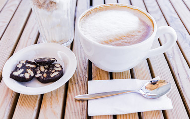 Cup of coffee with  chocolate candies