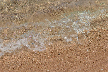The sea wave runs on the sand