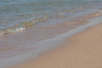 The sea wave runs on the sand