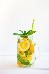 Fototapeta premium Homemade iced lemonade with mint, summer fruits and berries in a mason jar. Copy space background