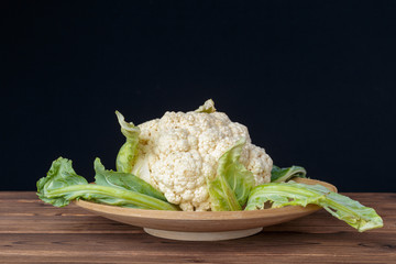 Organic cauliflower on wooden background