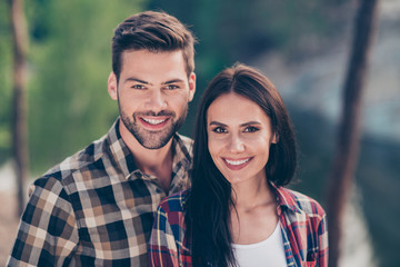 Fototapeta premium Portrait of nice lovely couple, spouses wearing casual checkered