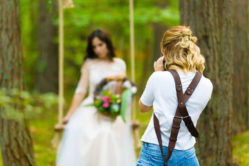 Professional wedding photographer taking close-up portraits of the bride