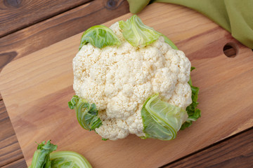 Organic cauliflower on wooden background