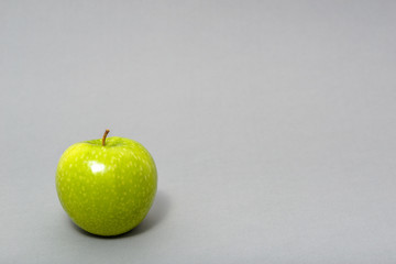 Fresh green apple isolated on gray background