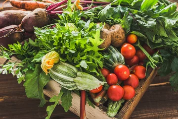 Fotobehang Assortment of fresh organic vegetables and garden produce on farmer market, healthy diet with vegetarian ingredients © alicja neumiler