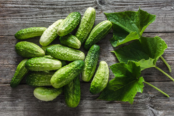Fresh cucumbers on wooden table, vegetables on local farmer market