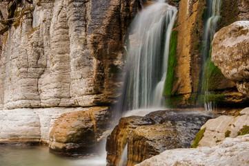 Georgous huge waterfall on the mountain river among the rocks