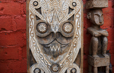 Group of different  Balinese wooden statues displayed in art and craft tourist market. Indonesian handicrafts. Souvenir from Bali. Traditional wood carving. Сounter with balinese souvenirs..