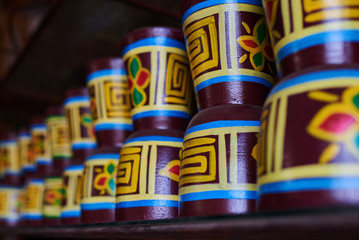 Fototapeta na wymiar Colorful souvenir background. Handmade ceramic vases. Clay pots stacked for sale. Pottery making place. Craft market. Craftsmanship. Traditional clay pottery. Shop of pottery. Selective focus.