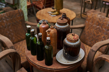 Various vintage objects and furniture for sale at a indoor flea market. View of a display full of interesting old things for sale. Many groups of vintage assorted second-hand objects.