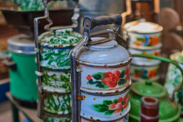 Set of old kitchen tools. Retro equipment of cooking. Various objects for sale at a indoor flea market. View of a display full of interesting old things for sale. Vintage assorted second-hand objects.
