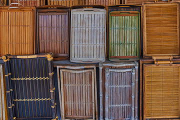 Typical souvenir shop selling souvenirs and handicrafts of Bali at the famous Ubud Market, Indonesia. Balinese market. Souvenirs of wood and crafts of local residents. Various bamboo trays.