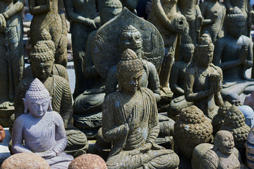 Typical souvenir shop selling souvenirs and handicrafts of Bali at the famous Ubud Market, Indonesia. Balinese market. Souvenirs of stone and crafts of local residents. Statues made from stone.