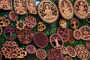 Souvenirs and handicrafts of Bali at the famous Ubud Market. Hindu and Buddhist wooden carving in the outside wood-carver's workshop in the tourist resort. Gifts, nice memories of vacation.