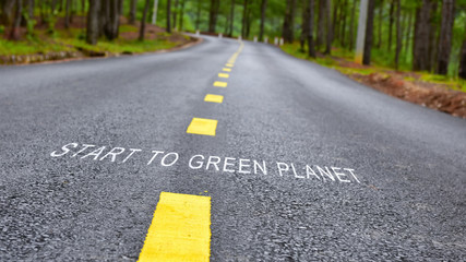 Start to green planet words on road surface, nature concept and save the earth idea