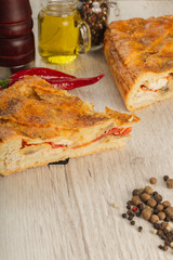 Meat pie on a wooden background with ingredients.