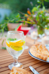 Family outdoor dinner in the garden in summer at sunset. Picnic food and drink concept