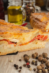 Meat pie on a wooden background with ingredients.