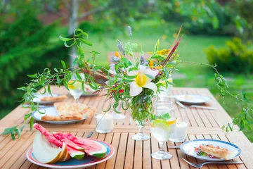  Family outdoor dinner in the garden in summer at sunset. Picnic food and drink concept © yatcenko