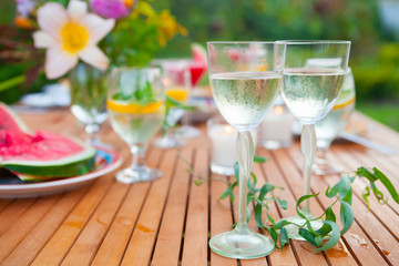 Family outdoor dinner in the garden in summer at sunset. Picnic food and drink concept