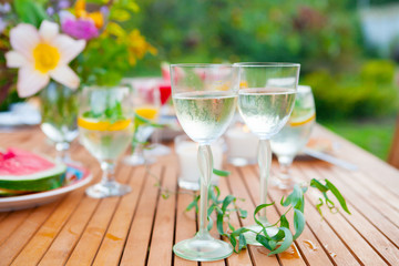 Family outdoor dinner in the garden in summer at sunset. Picnic food and drink concept