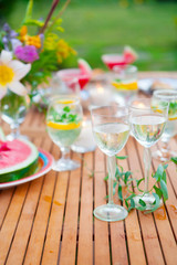 Family outdoor dinner in the garden in summer at sunset. Picnic food and drink concept