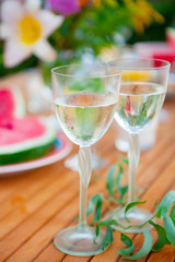 Family outdoor dinner in the garden in summer at sunset. Picnic food and drink concept