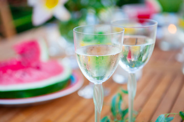 Family outdoor dinner in the garden in summer at sunset. Picnic food and drink concept