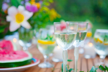 Family outdoor dinner in the garden in summer at sunset. Picnic food and drink concept