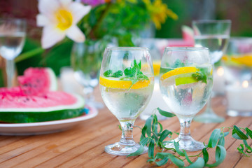 Family outdoor dinner in the garden in summer at sunset. Picnic food and drink concept