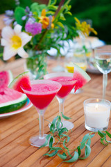 Family outdoor dinner in the garden in summer at sunset. Picnic food and drink concept