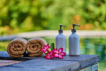 Beauty concept with spa products set. Spa composition for body care on swiming pool background. Relaxing spa resort composition.