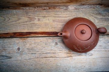 clay teapot on an old board