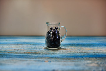 On the vintage wooden desk is a glass decanter where cooked cherries for making jam