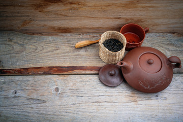 clay teapot on an old board
