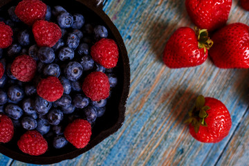 Delicious berries. Strawberries, blueberries and raspberries. Healthy summer fruits, antioxidants. Healthy food. Delicious nature vegetarian ingredient. Top view with copy space.