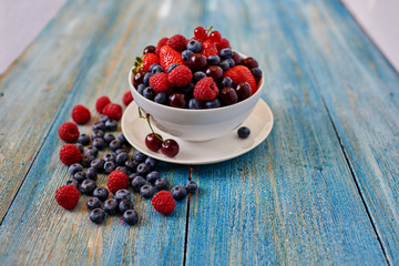Fresh berries are heaped in a deep dish