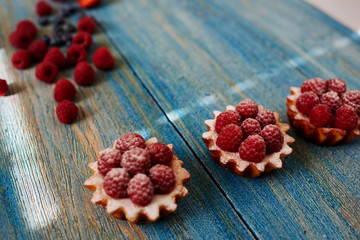 Three tartlets laid out neatly on the table, the chef in the confectionery is going to serve their guests coffee shop