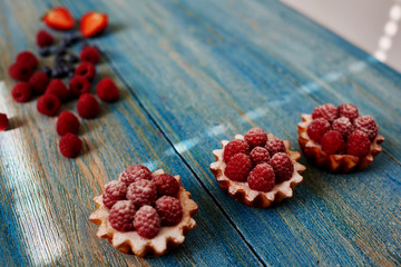 Three tartlets laid out neatly on the table, the chef in the confectionery is going to serve their guests coffee shop