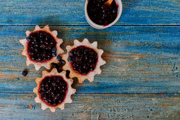 Close-up of mouth-watering tartlets are on the table, the cook is going to serve them with fresh...