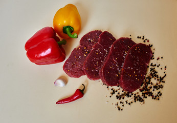 Chef Italian restaurant cut fresh lamb steaks, garlic, red pepper and fresh peppers big one will prigotvlen sauce for meat