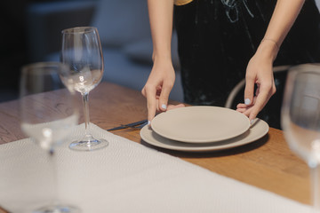 Fototapeta na wymiar Woman Setting up Dinner Table