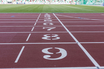 Red sport track for running on public stadium. Running healthy lifestyle concept. Sports background abstract texture