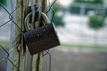 Steel rusted Closed Padlock on aluminium mesh