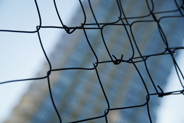 Mesh aluminium wire with defocused background, business concept