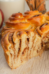 Pie with apples and cinnamon on a wooden background with ingredients.