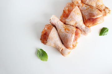 Chicken drumstick in marinade on a light background