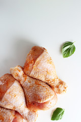 Chicken drumstick in marinade on a light background