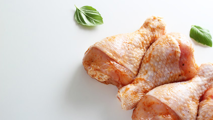 Chicken drumstick in marinade on a light background